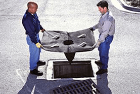 Two Men Holding a Sediment Filter